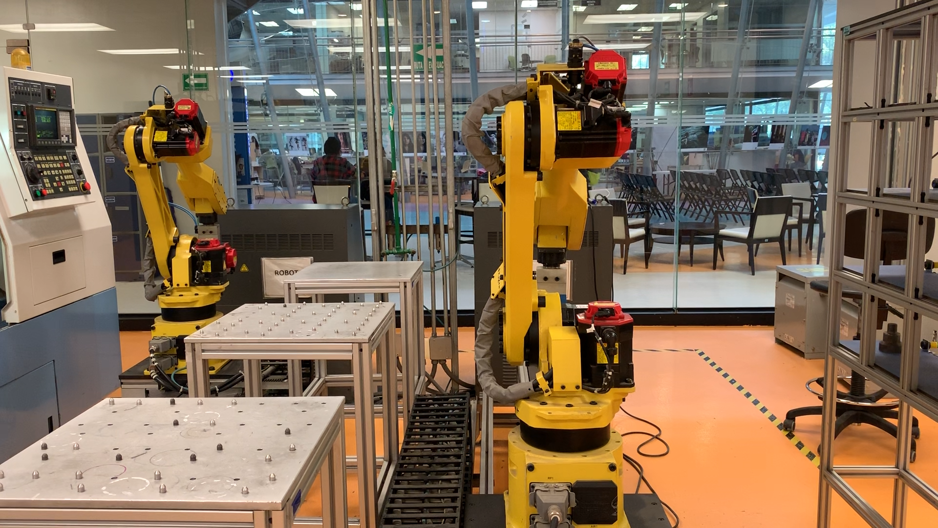 Industrial robot cell with two articulated arms and physical work areas